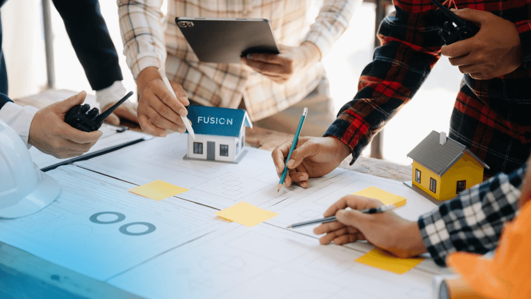 Team planning housing project with Fusion model and blueprints